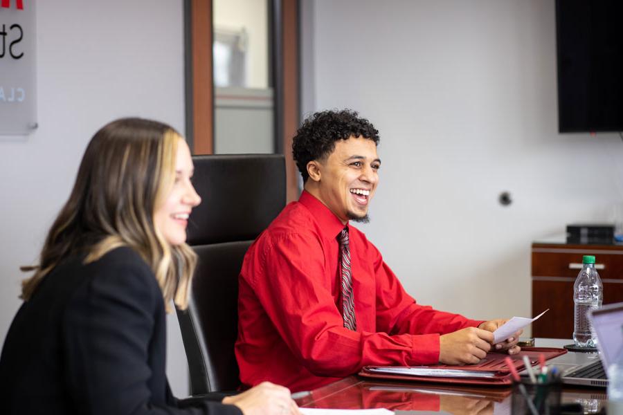 Students sitting around a table in a business meeting